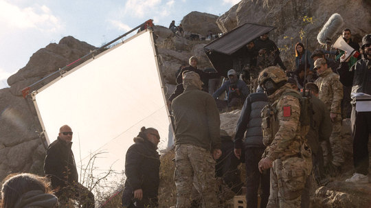 Lighting team setting up among the rocks