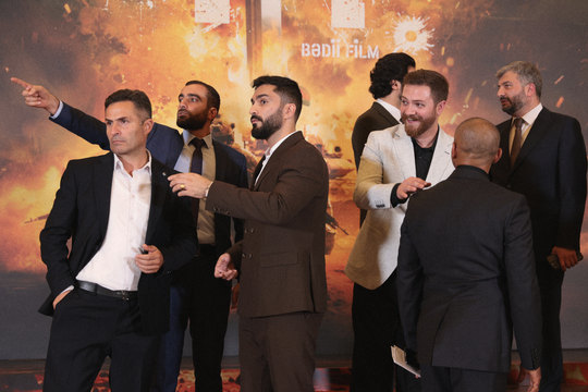 The team of 44 at the premiere backdrop