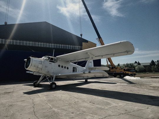An-2 aircraft in front of the blue-screen wall on the airfield set