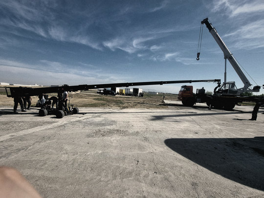 Crane arm and the An-2 on the airfield