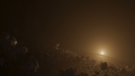 An asteroid field lit by a distant star